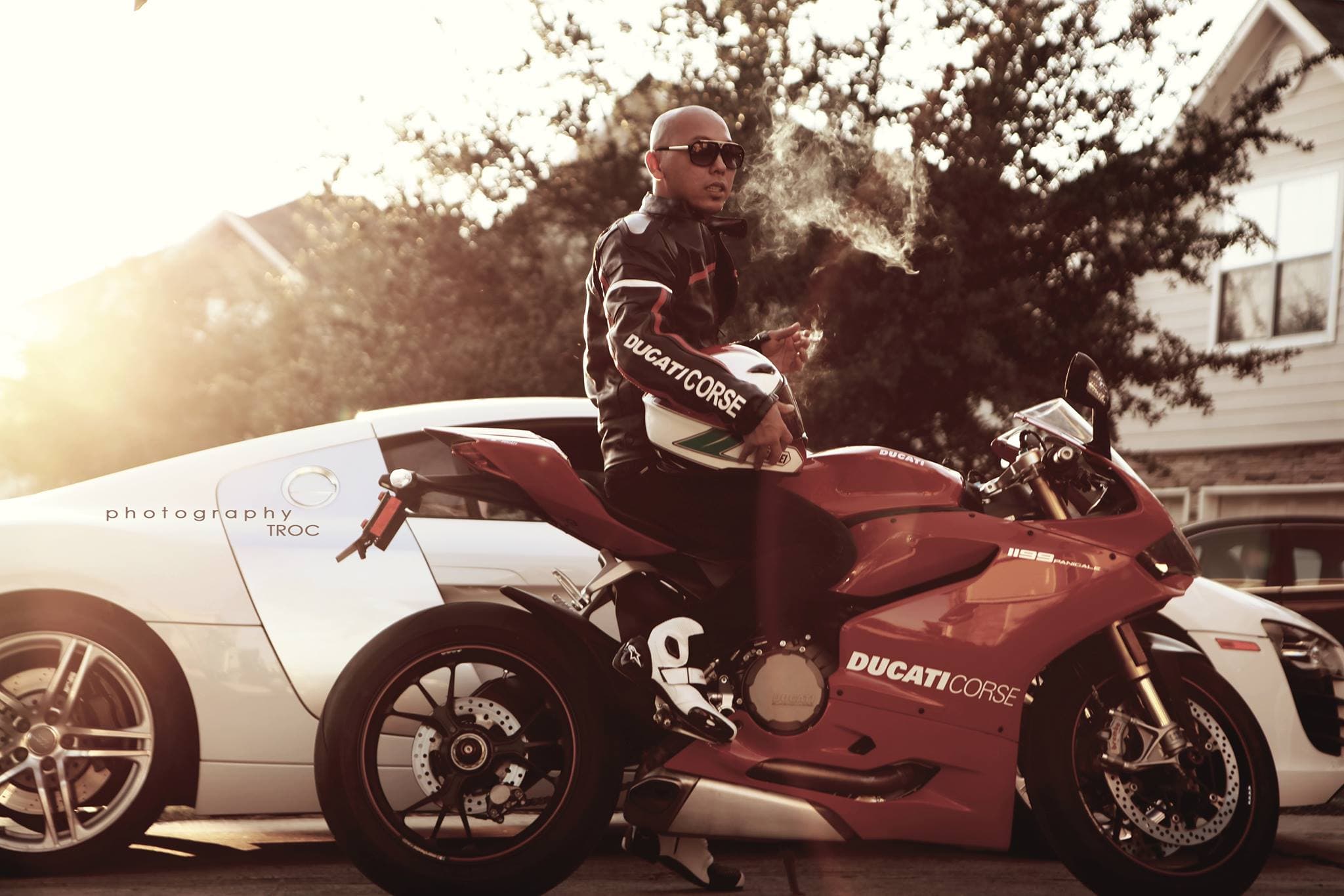 HoaDang with a Ducati motorcycle and Audi R8