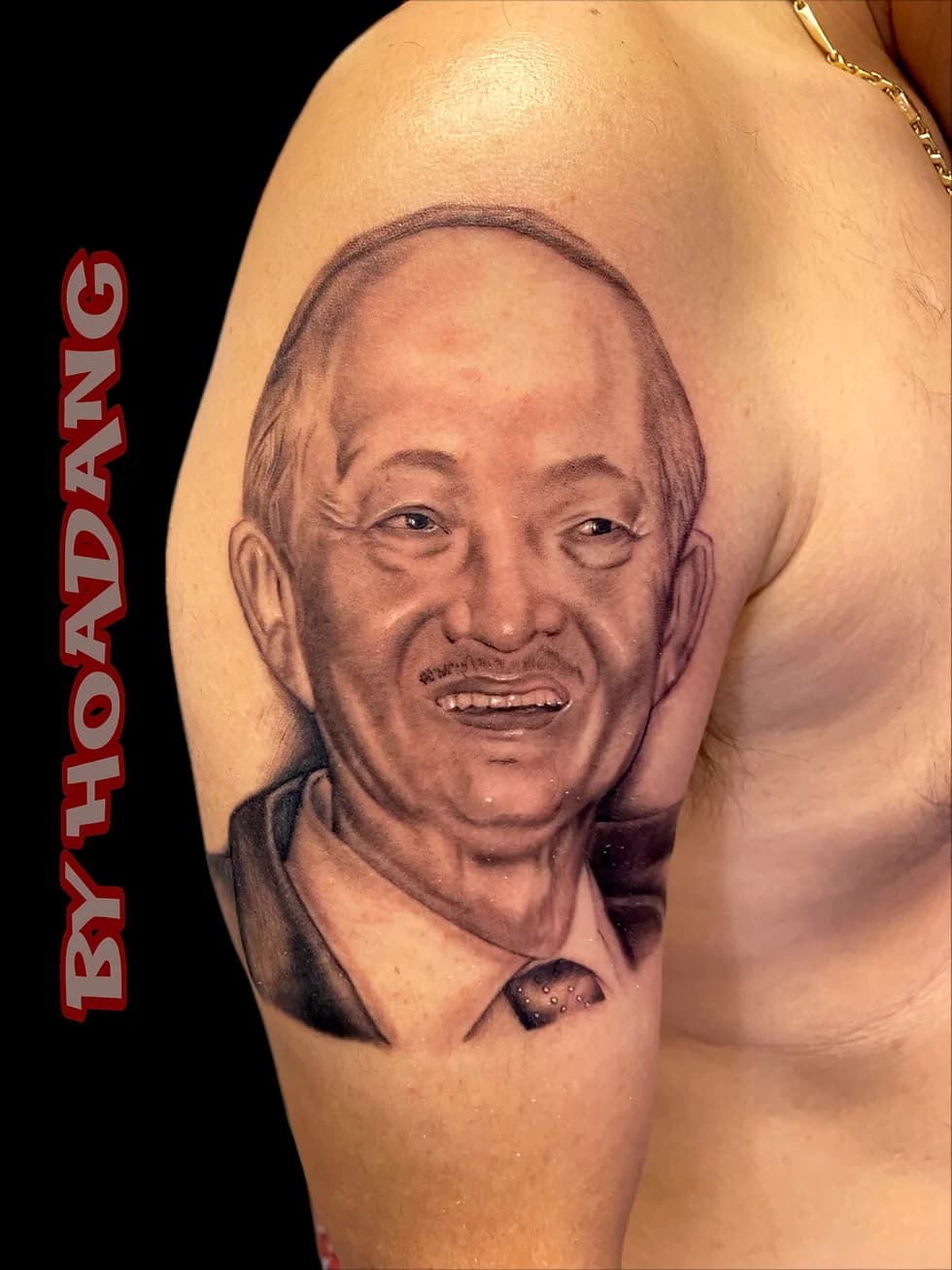 Realistic black and grey portrait tattoo by HoaDang